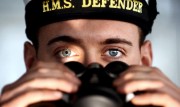Navy officer looking through binoculars